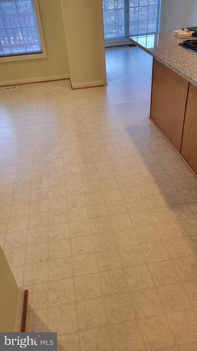 interior space with baseboards and tile patterned floors