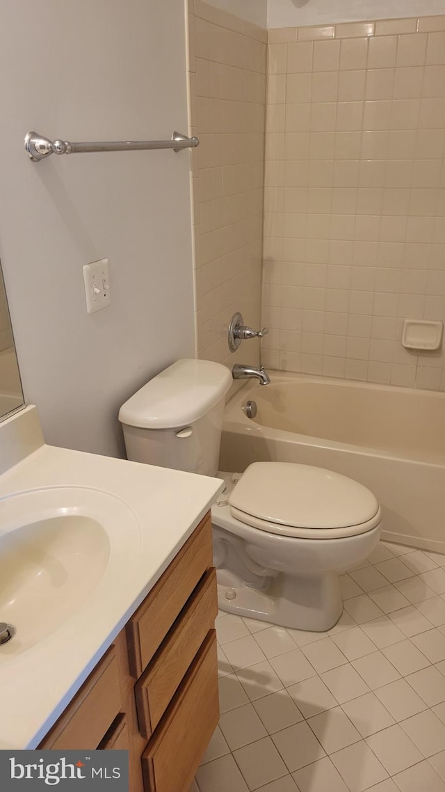 bathroom featuring toilet, tile patterned floors, shower / bathing tub combination, and vanity