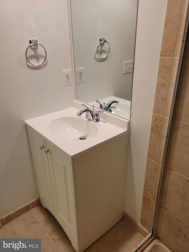 bathroom featuring baseboards, vanity, and tile patterned floors