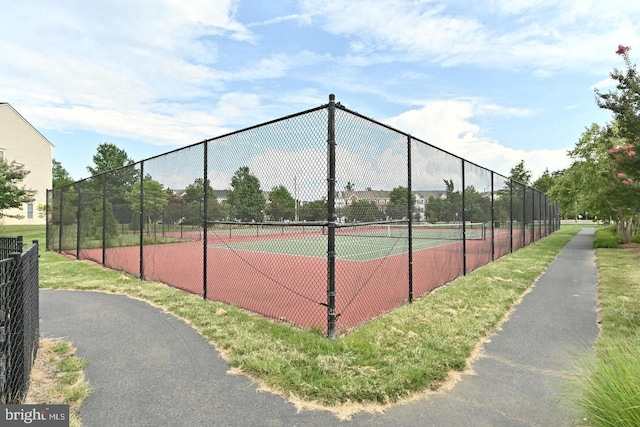 view of sport court featuring fence