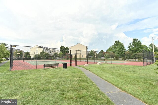 surrounding community with a tennis court, a yard, and fence