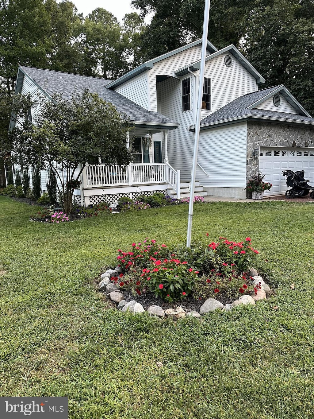 traditional-style house featuring a garage and a front yard