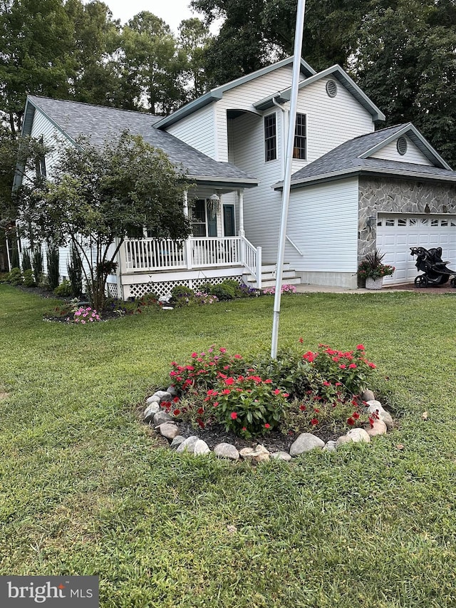 traditional-style house featuring a garage and a front yard