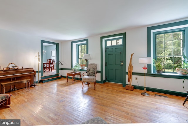 entrance foyer with light wood-type flooring, visible vents, and baseboards