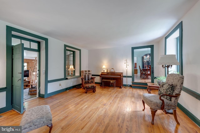 sitting room featuring light wood-style flooring and baseboards