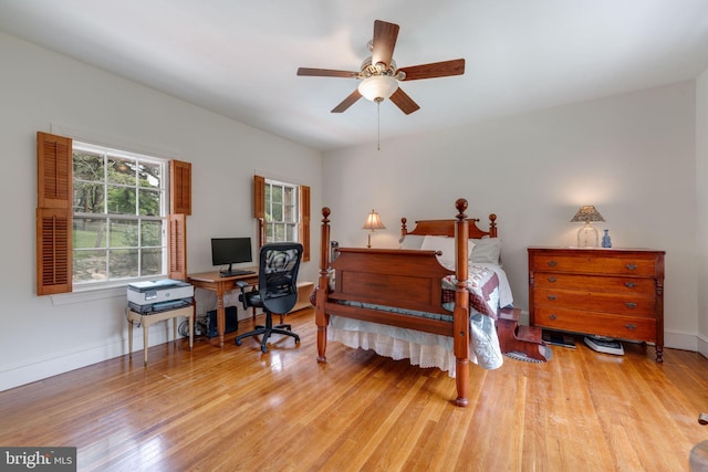 bedroom with wood finished floors and baseboards