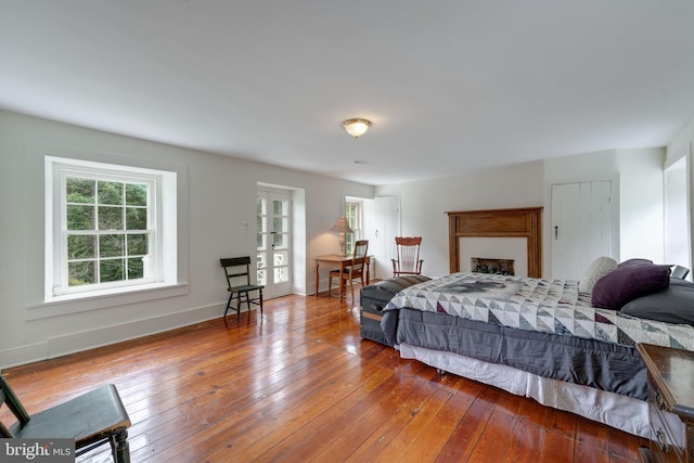 bedroom with hardwood / wood-style flooring and baseboards