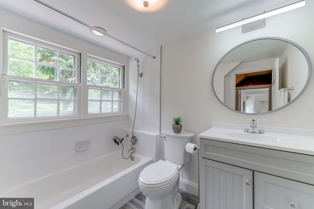 bathroom featuring baseboards, shower / bath combination, vanity, and toilet