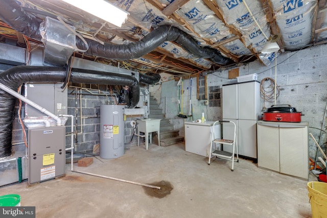 unfinished below grade area with fridge, a sink, electric water heater, and heating unit