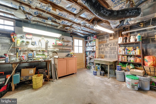 interior space featuring concrete block wall and a workshop area