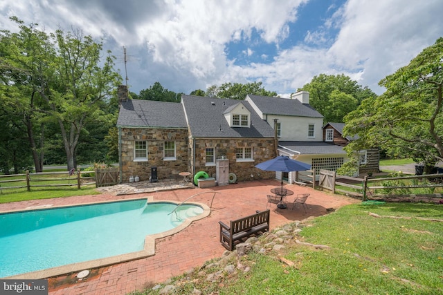 view of pool with a fenced in pool, a patio, a lawn, an outdoor fire pit, and fence