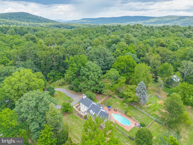 aerial view with a mountain view and a wooded view