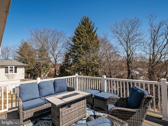 wooden terrace with an outdoor living space