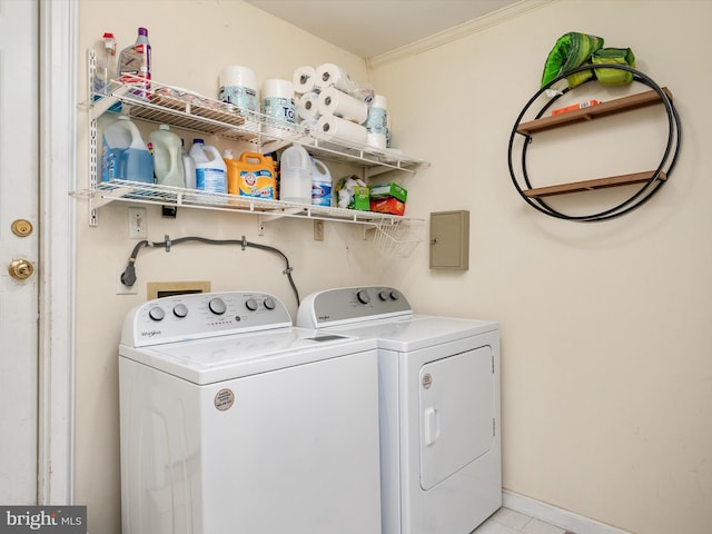 laundry room with washing machine and clothes dryer, laundry area, crown molding, and baseboards