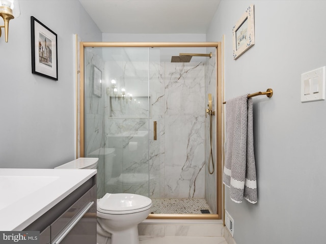 bathroom with a marble finish shower and toilet