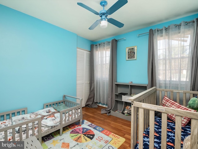 bedroom with a closet, ceiling fan, and wood finished floors