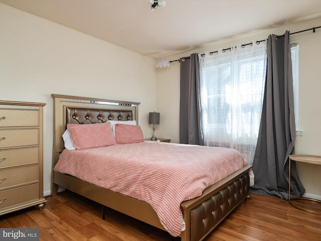 bedroom featuring wood finished floors