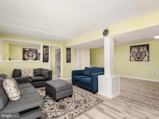 living area with recessed lighting, wood finished floors, and baseboards