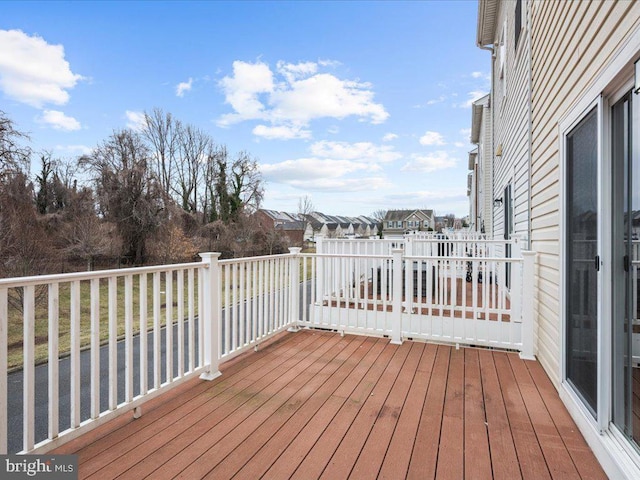 wooden terrace featuring a residential view