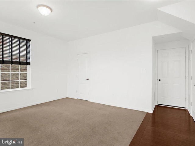 spare room with baseboards