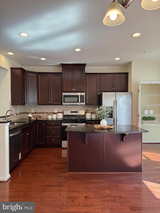 kitchen featuring dark wood-style floors, stainless steel appliances, dark brown cabinets, and a sink