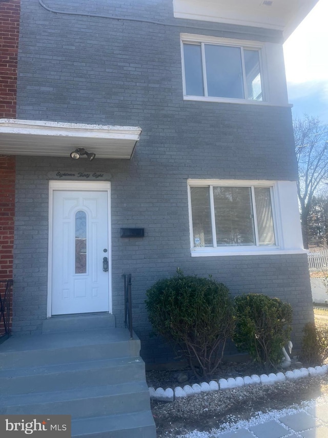 entrance to property with brick siding