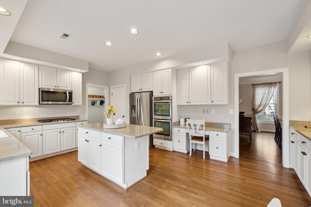 kitchen with recessed lighting, visible vents, light wood-style flooring, appliances with stainless steel finishes, and white cabinets