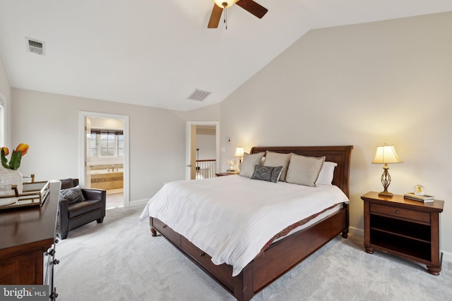 bedroom with light carpet, vaulted ceiling, ensuite bath, and visible vents