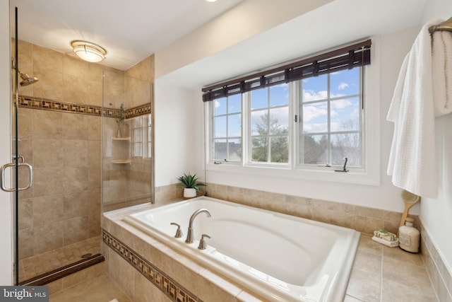 full bath featuring a stall shower, a garden tub, and tile patterned floors