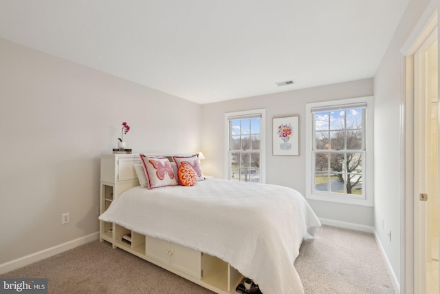 bedroom featuring carpet, visible vents, and baseboards