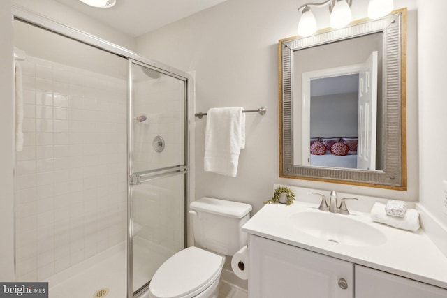 full bath featuring a stall shower, vanity, and toilet