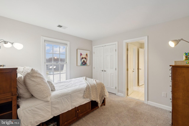 bedroom with baseboards, a closet, visible vents, and light colored carpet