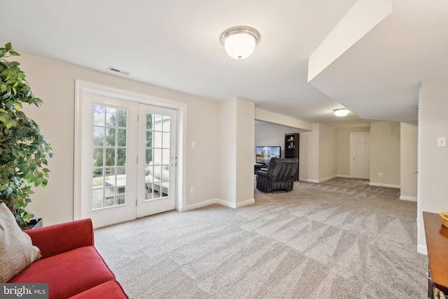 carpeted living room featuring visible vents and baseboards