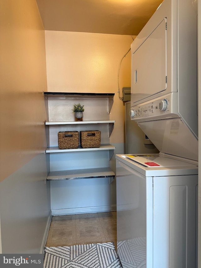 laundry room with stacked washer and dryer and laundry area