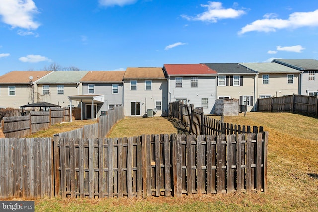 exterior space with a fenced backyard and a residential view