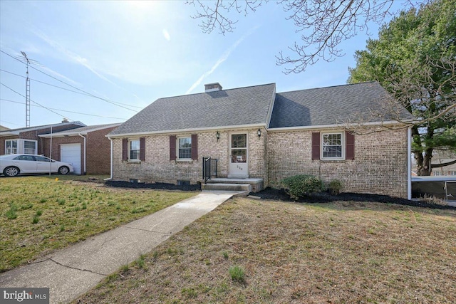 ranch-style house featuring a front yard, a garage, brick siding, and a chimney