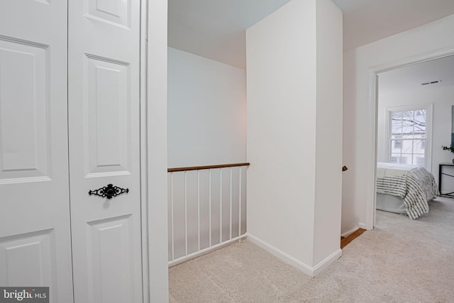 hall with carpet and baseboards