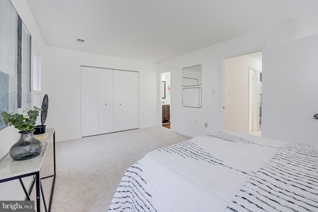 bedroom featuring carpet, a closet, visible vents, and baseboards