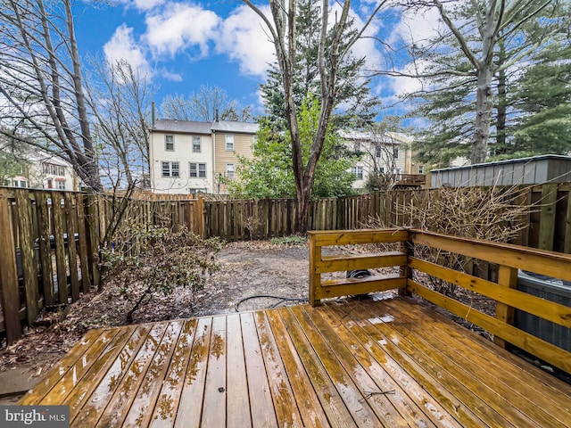 wooden terrace featuring a fenced backyard