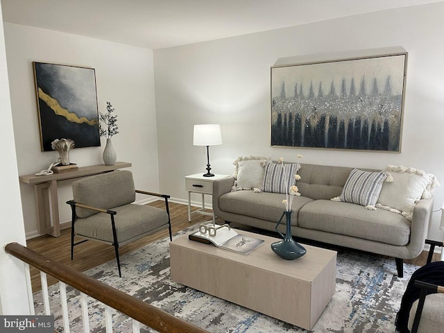 living room featuring baseboards and wood finished floors