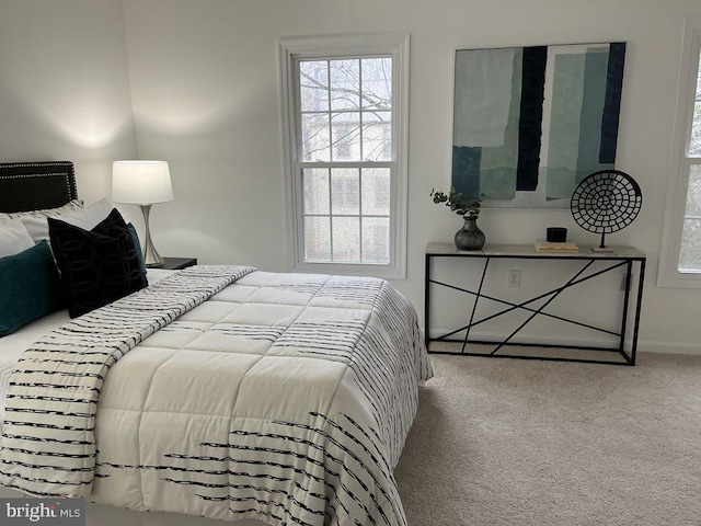 bedroom featuring carpet and baseboards