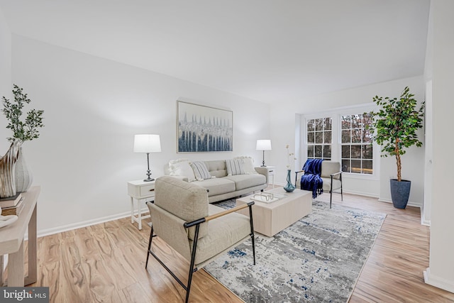 living area with light wood-style floors and baseboards