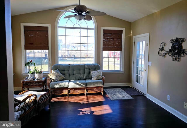 interior space featuring lofted ceiling, ceiling fan, baseboards, and dark wood finished floors