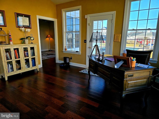 misc room with baseboards and wood finished floors