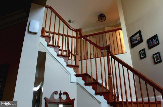 stairs with ornamental molding and visible vents