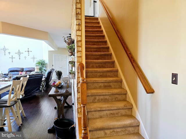 stairs featuring baseboards and hardwood / wood-style floors