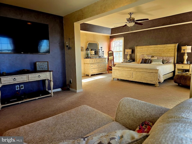 carpeted bedroom featuring baseboards and a ceiling fan