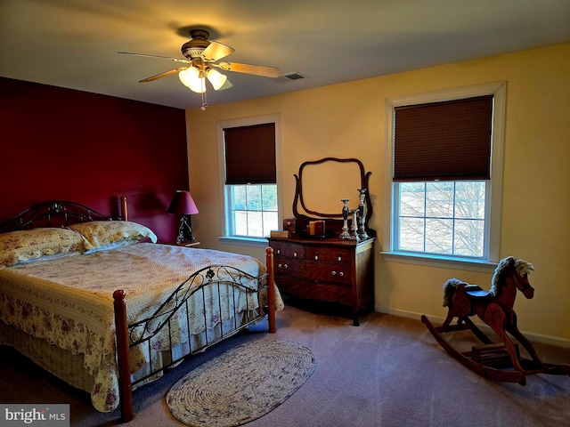 bedroom with carpet, visible vents, ceiling fan, and baseboards