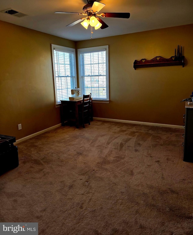 unfurnished bedroom with a ceiling fan, carpet, visible vents, and baseboards