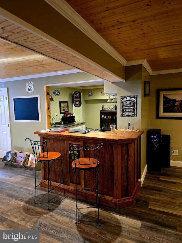 bar with indoor wet bar, wood finished floors, and wood ceiling